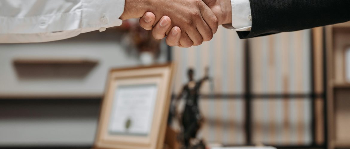 Lawyer-Client-Shaking-Hands A lawyer and client shaking hands in a law office
