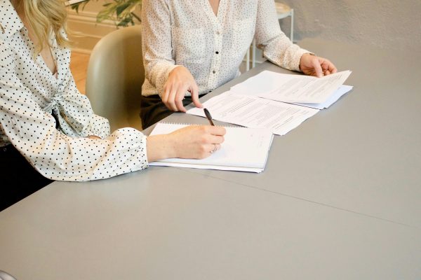 Lawyer reviewing legal documents with client
