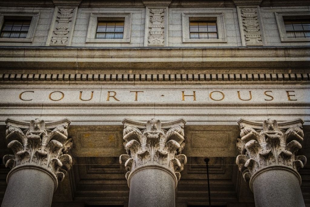 a close-up view of a courthouse with pillars and windows