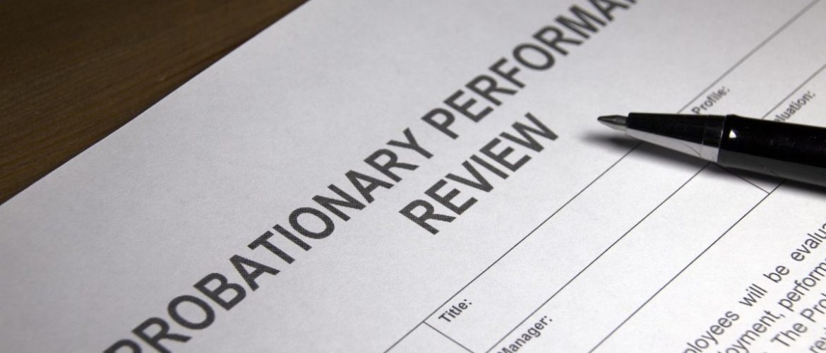 probation a close up of a probationary performance review document and pen