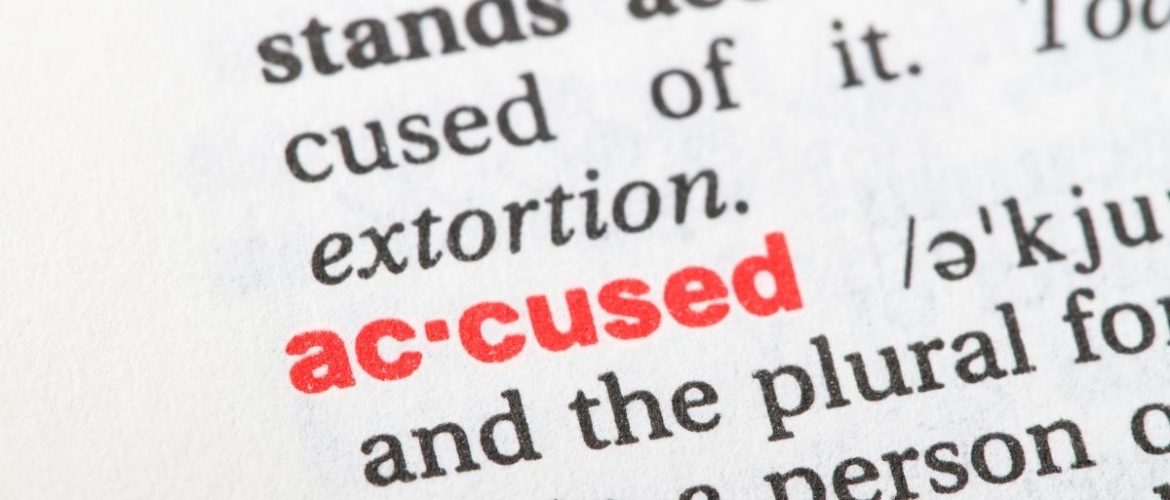 accused text in a dictionary highlighting the word "accused" in red