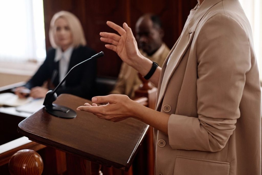 view of someone's torso who is giving testimony in a courtroom